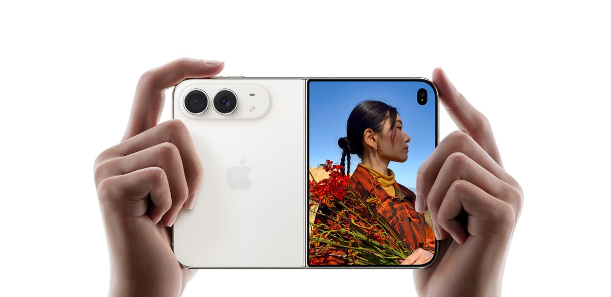 Manos sosteniendo el iPhone Duo medio abierto, usado como cámara.